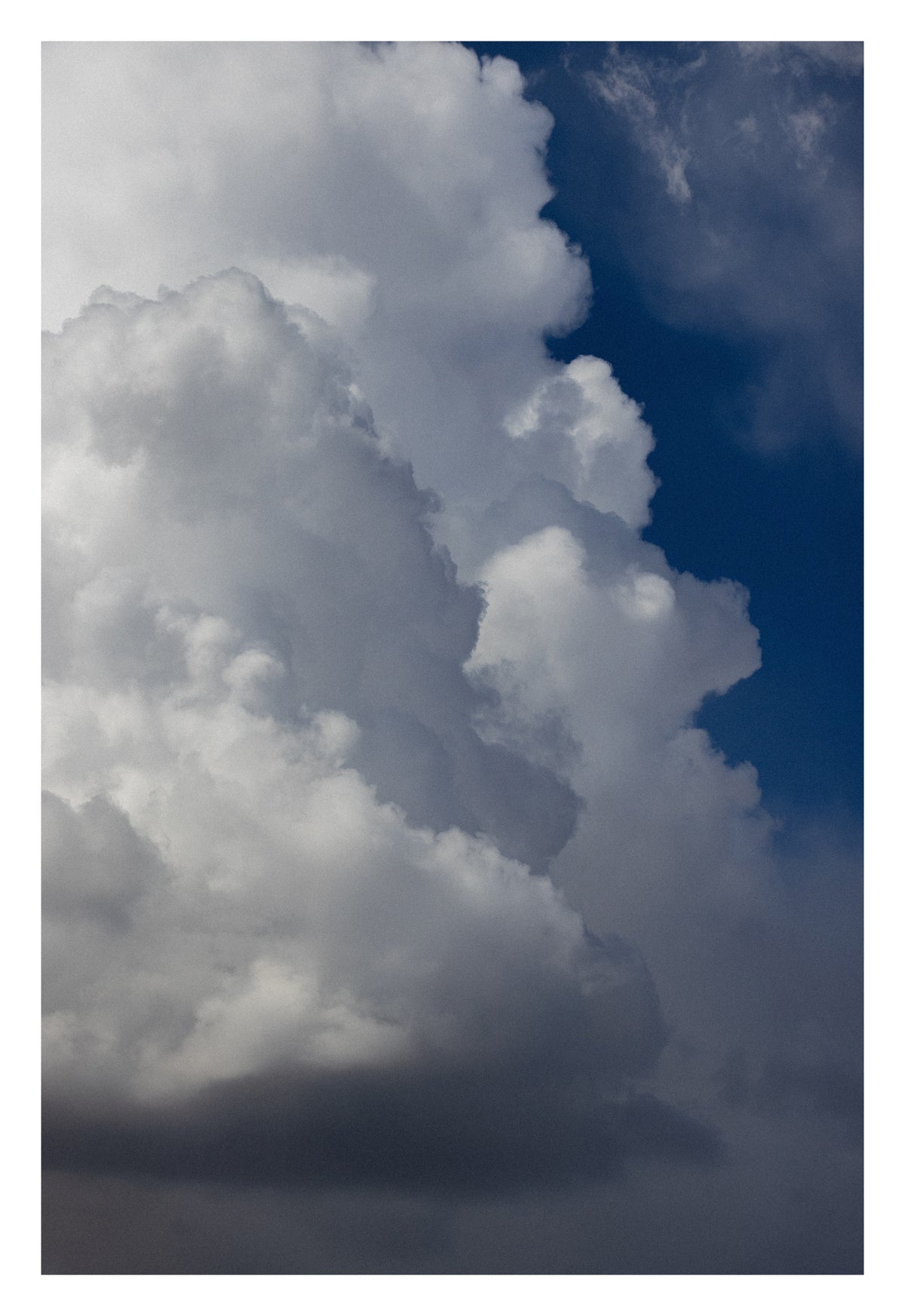 A monumental Alberta sky that makes you feel your own scale. Shown with the white signing border.