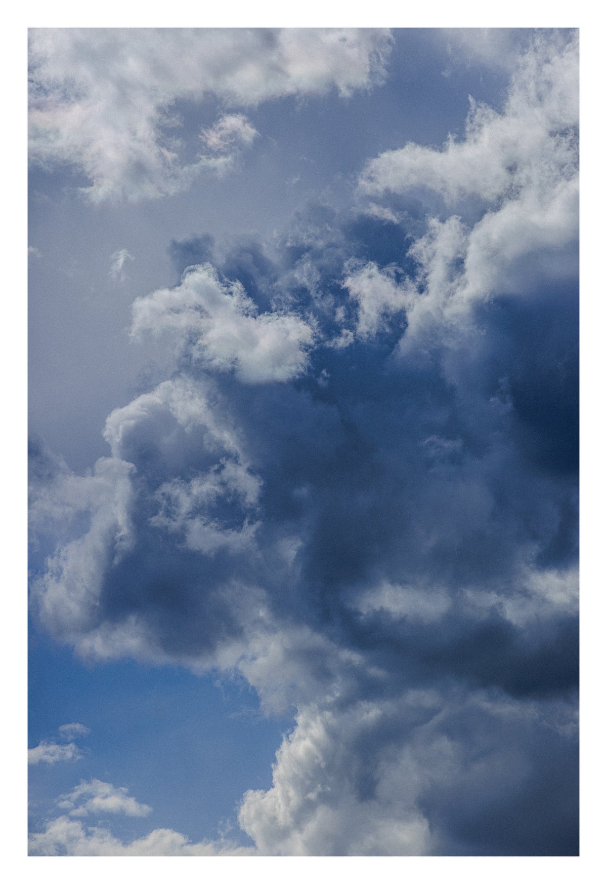 A deep blue-grey Alberta sky between storm and silver. Shown with the white signing border.