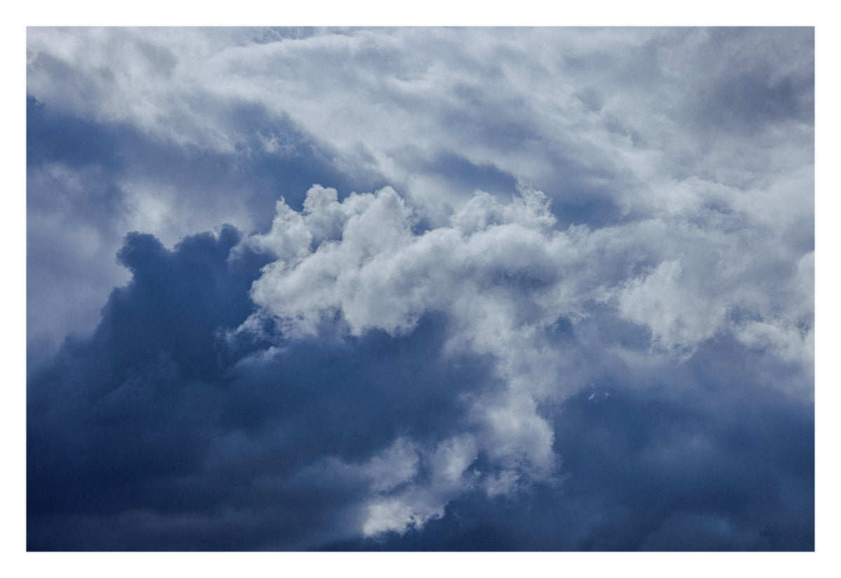Blue-grey Alberta cloud layered like ocean depth. Shown with the white signing border.