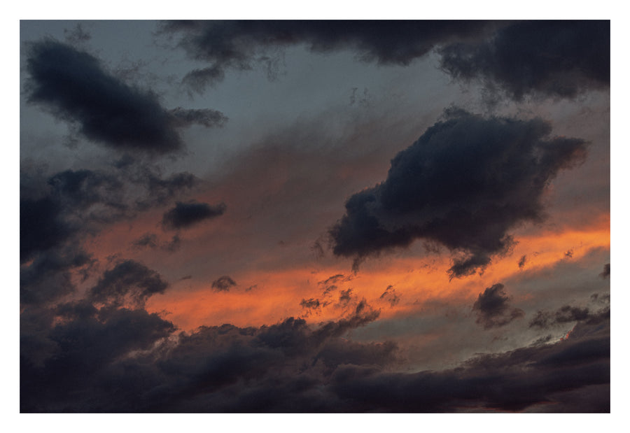 A warm desert-toned Alberta sky, the clouds carrying the weight of dunes. Shown with the white signing border.