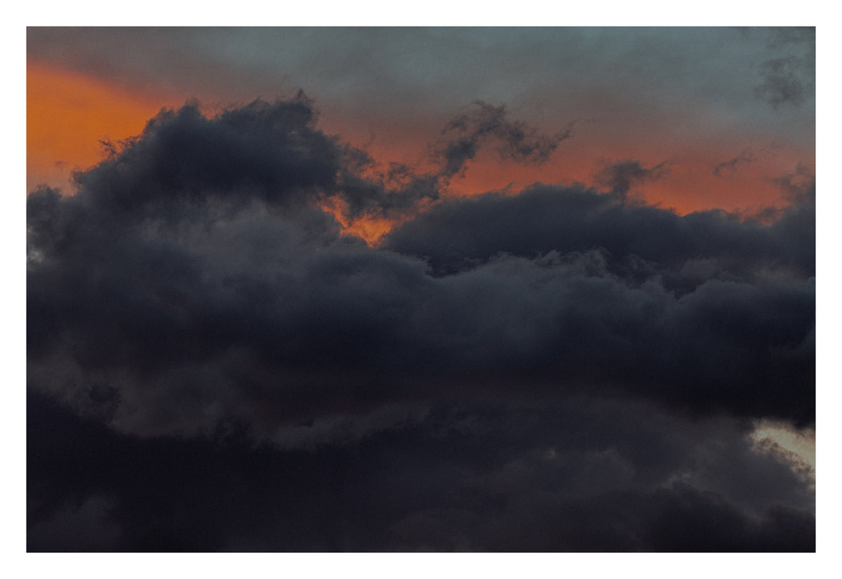 An Alberta sky suspended in eerie stillness. Shown with the white signing border.