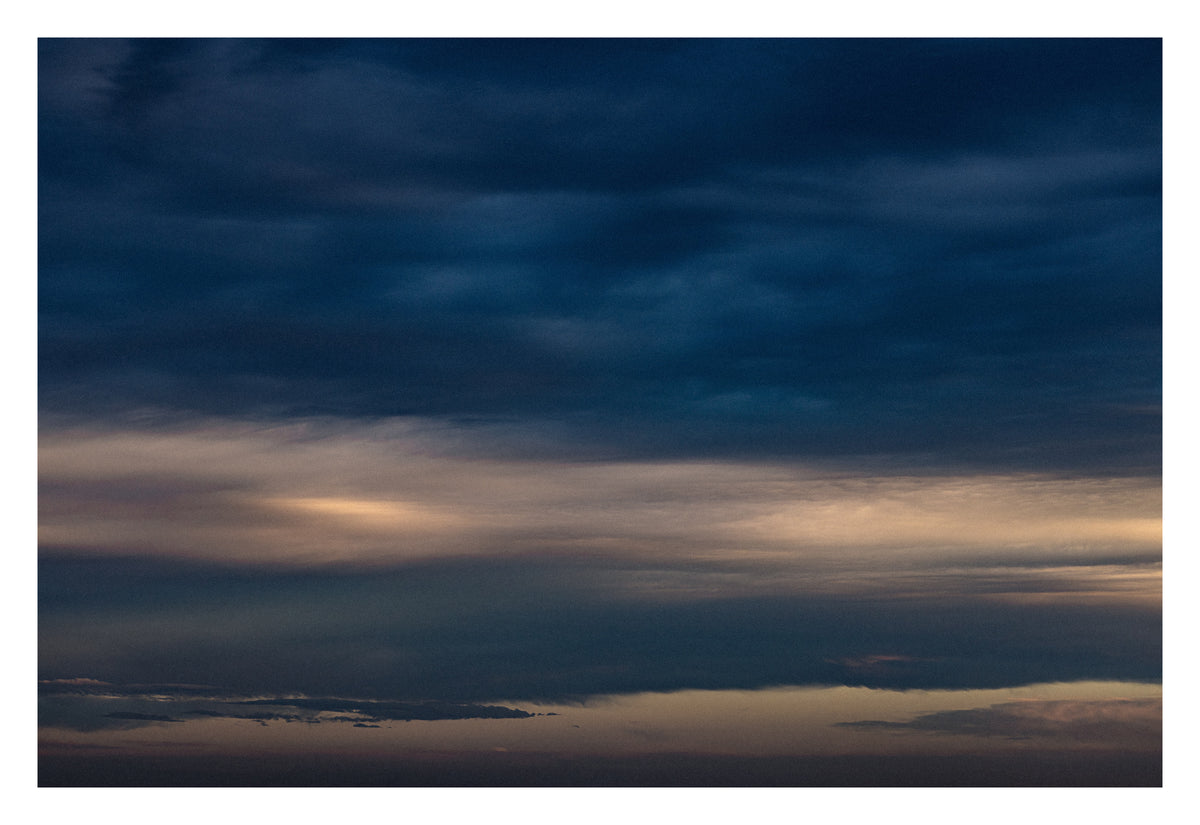 Cloud formations gathered at the horizon's edge. Shown with the white signing border.