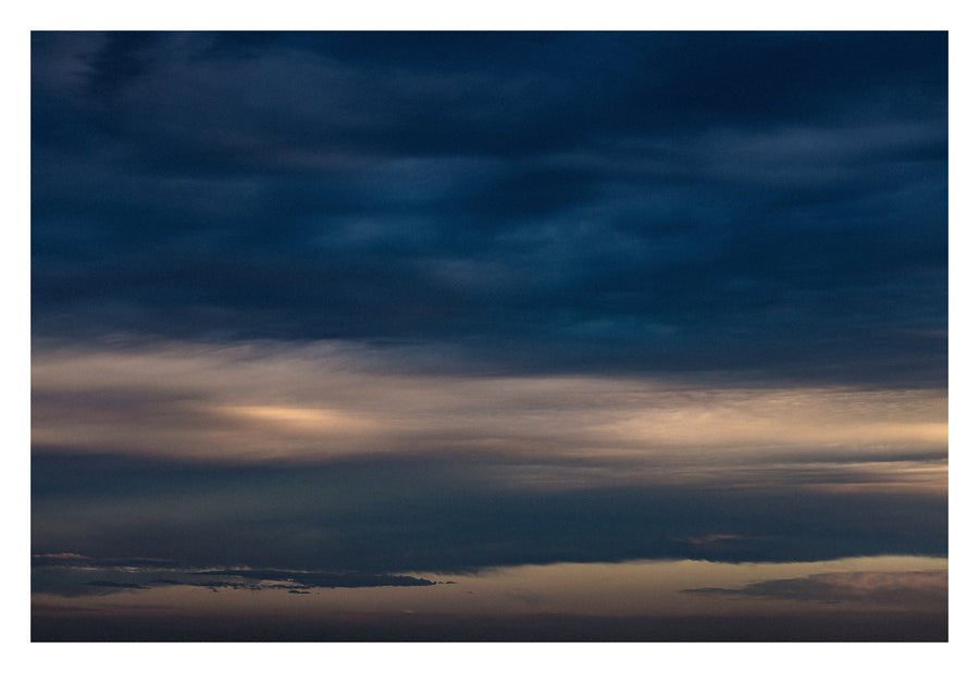 Cloud formations gathered at the horizon's edge. Shown with the white signing border.