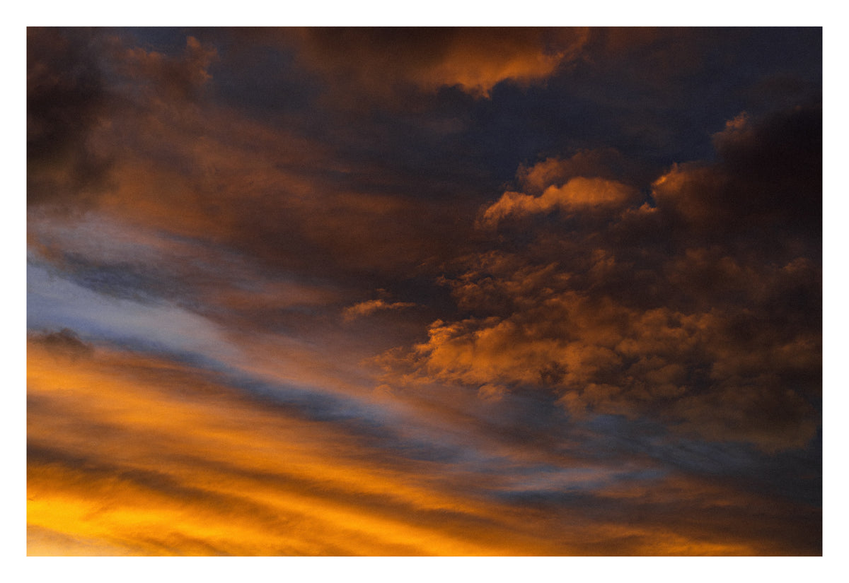 Soft Alberta cloud lit from within at the edge of dark. Shown with the white signing border.